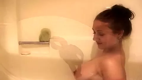 Busty solo shower slut fingers her pussy