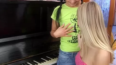 Sexy lesbians toy muffs on piano