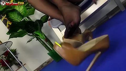 Femdome Alexya shows her feet off in black sheer nylons
