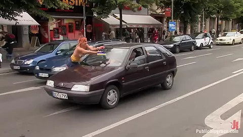 Flexible redhead is bound and stripped naked in public