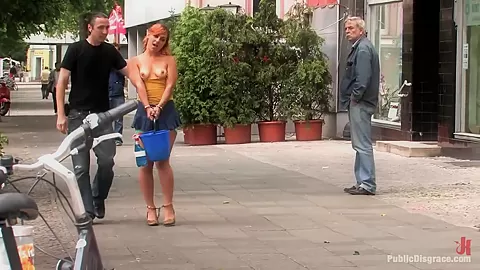 Flexible redhead is bound and stripped naked in public