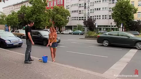 Flexible redhead is bound and stripped naked in public