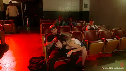 Slinky slut gives it up in an adult movie theater