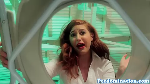 Redhead mistress teases sub with drops of pee