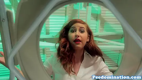 Redhead mistress teases sub with drops of pee