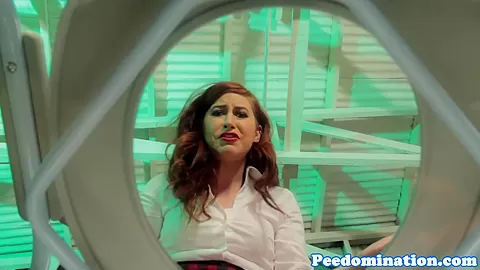 Redhead mistress teases sub with drops of pee