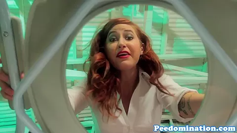 Redhead mistress teases sub with drops of pee