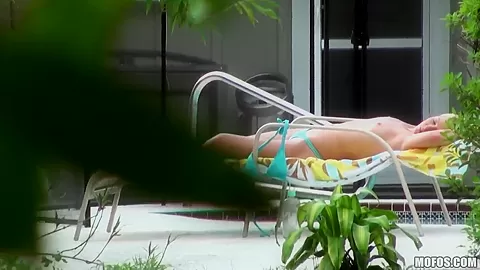 Hot neighbor babe, named Nikki, loves to tan topless in the backyard