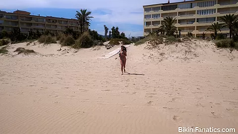 Busty babe in a sling bikini