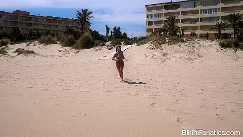 Busty babe in a sling bikini