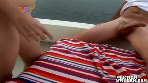 A innocent redhead sucks two dicks at sea