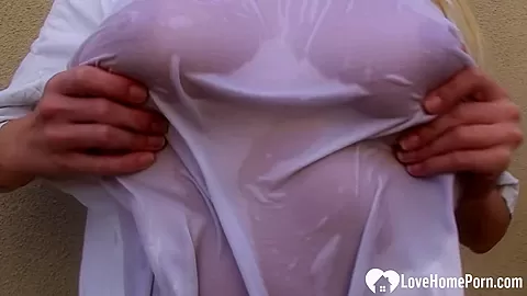 Teasing blonde shows her big boobs outdoors