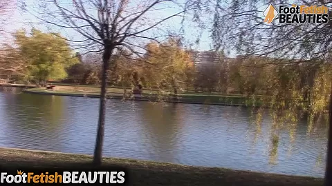 Barefoot redhead shows off her feet in public in the park