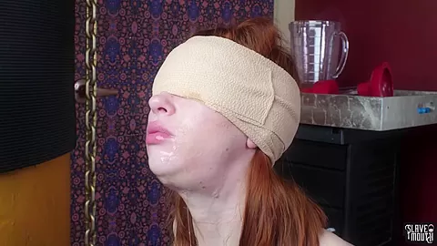 Blindfolded redhead slavegirl gagging cock