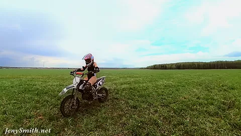 Naked woman riding a Dirt Bike