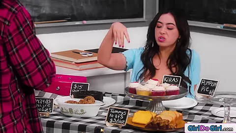 Busty stepmom licks stepdaughter under table during bakesale