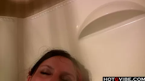 Busty redhead fingering in the shower