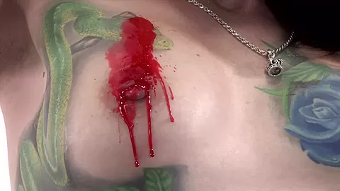 Tattooed babe Marie Bossette covers herself in hot wax