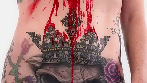 Tattooed babe Marie Bossette covers herself in hot wax