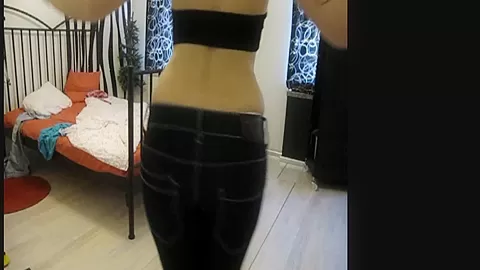 Tattooed redhead dances in a casual outfit
