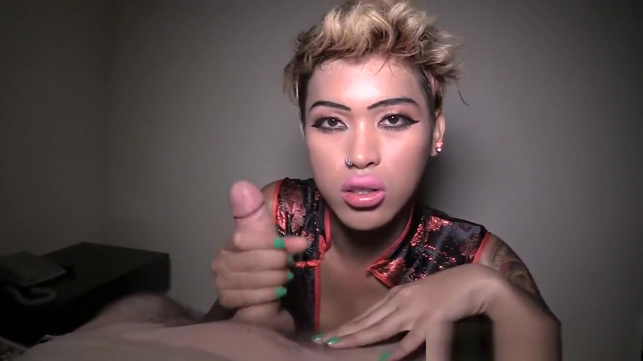 Ladyboy with a sexy and short haircut gives a handjob