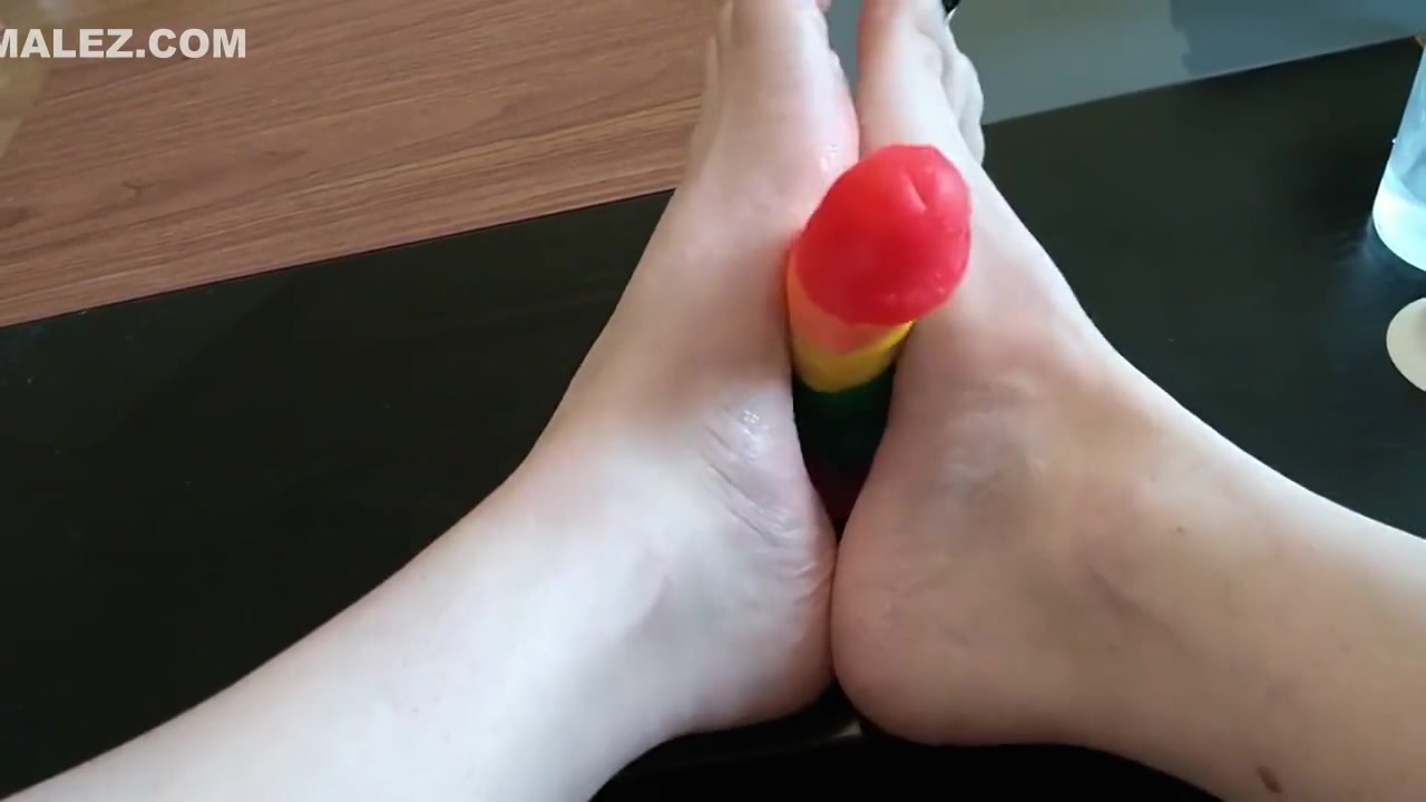 Femboy crossdresser gives rainbow dildo a footjob