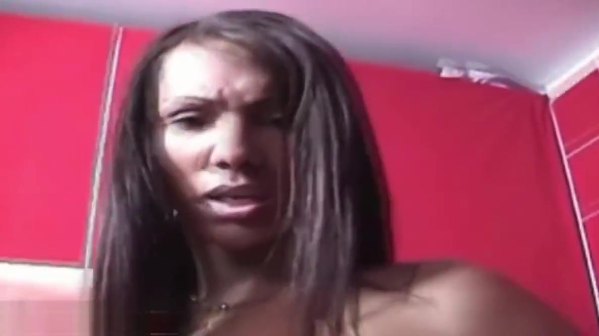 Black tranny with decent tits tugs her girl rod on red sofa