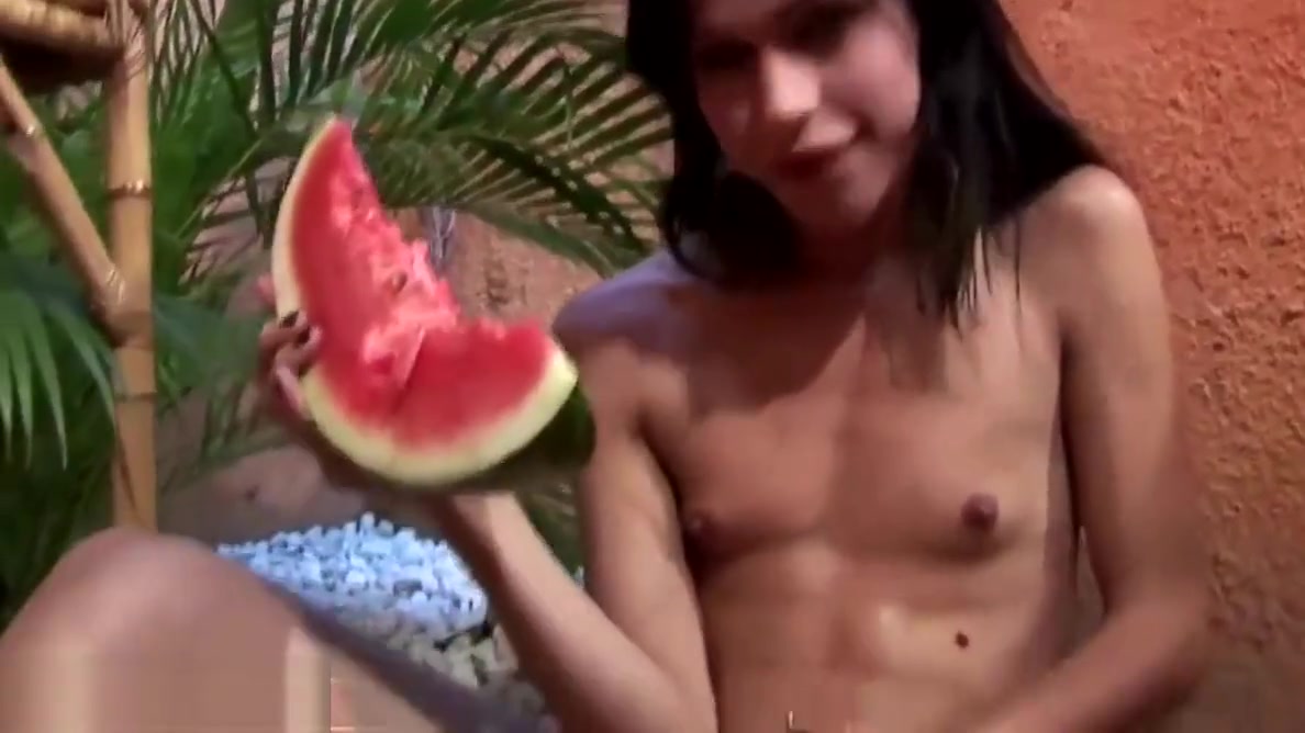 Slim tranny is riding watermelon glory hole and cums inside