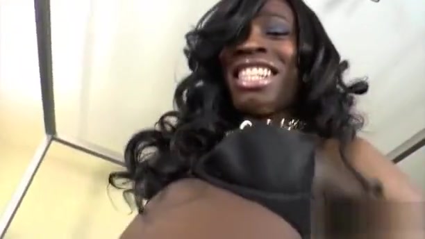 Ebony shemale wearing a sexy black lingerie masturbates