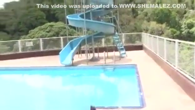 Latina Ts doll shows her tool by a pool