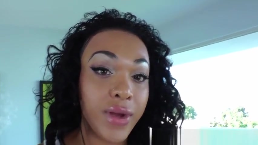 Black tranny tugging her pierced cock
