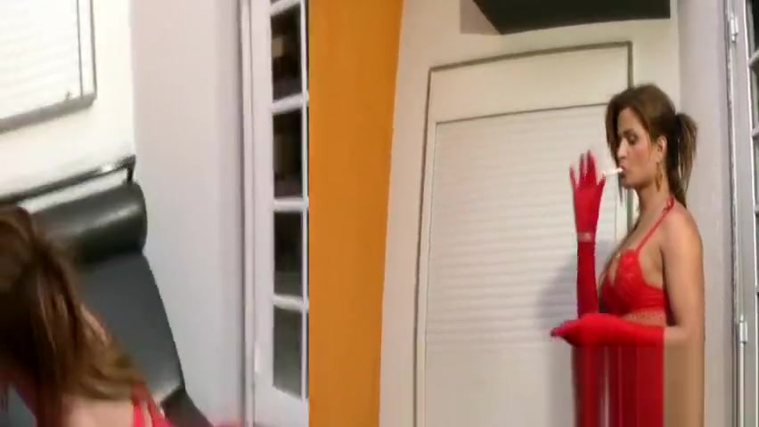 Hot t-babe in red fishnet overall strokes cock while smoking