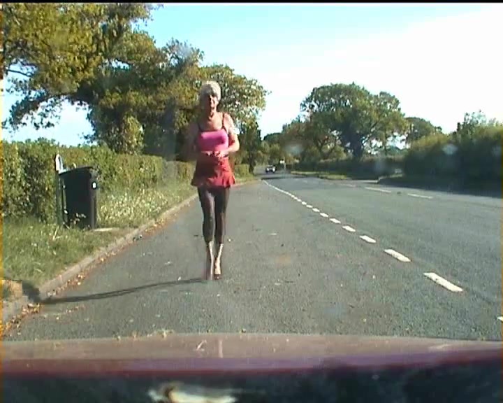 Amateur crossdresser in lingerie on a road