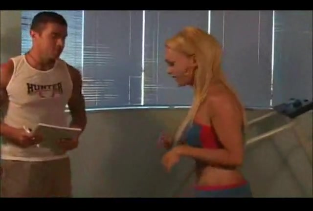 Sport instructor drills a busty shemale in a gym