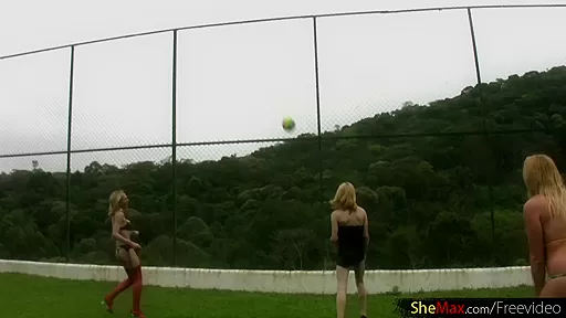 Four blonde chicks with dicks play volleyball and strip down