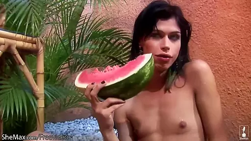 Chick with dick plays with her small titties and watermelon