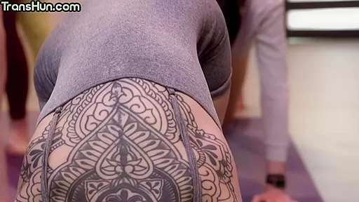Busty yoga TS fucks colored hair babe during public class
