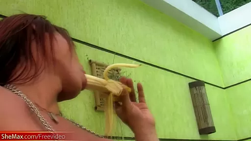 Redhead T-girl in see through dress enjoys her banana rama