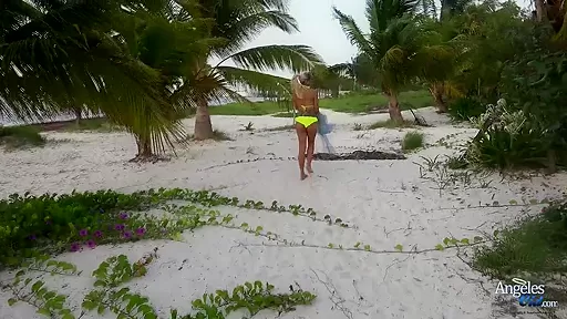 Sexy blonde babe taking off her bikini at the beach